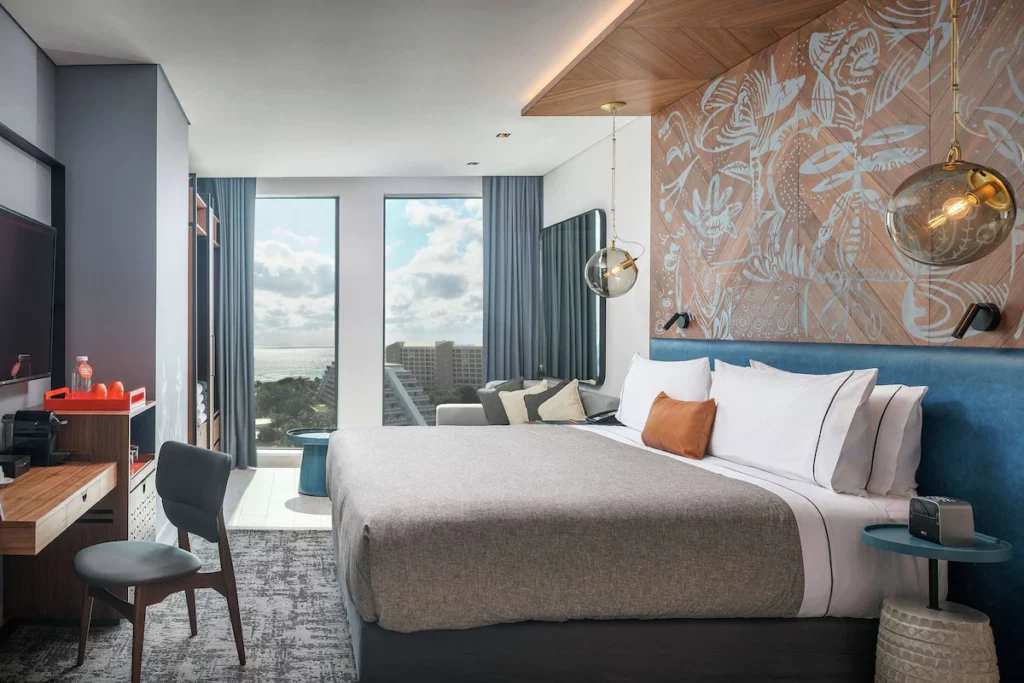 Double bed room with view of buildings and ocean 